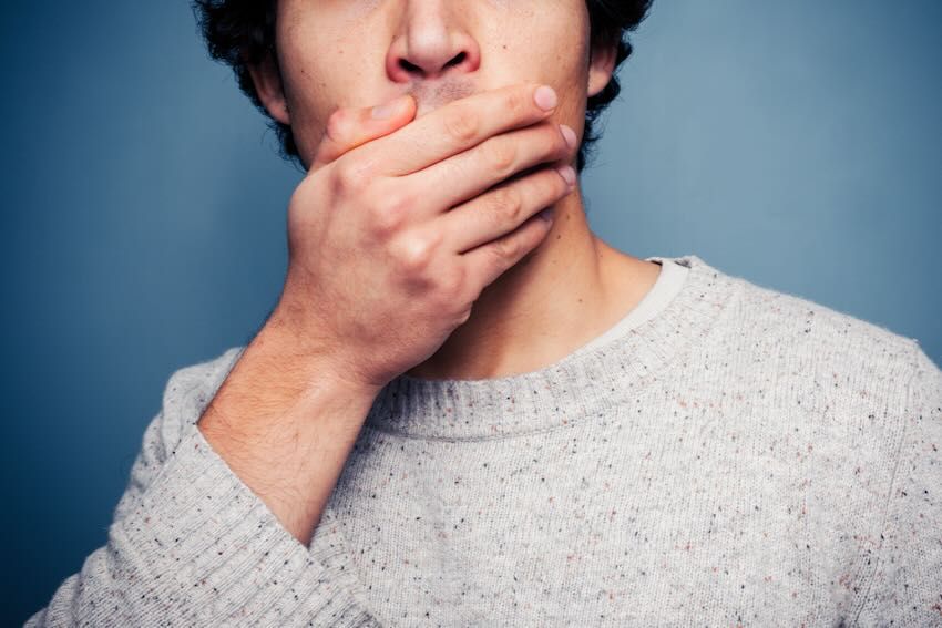 Hand over mouth AdobeStock